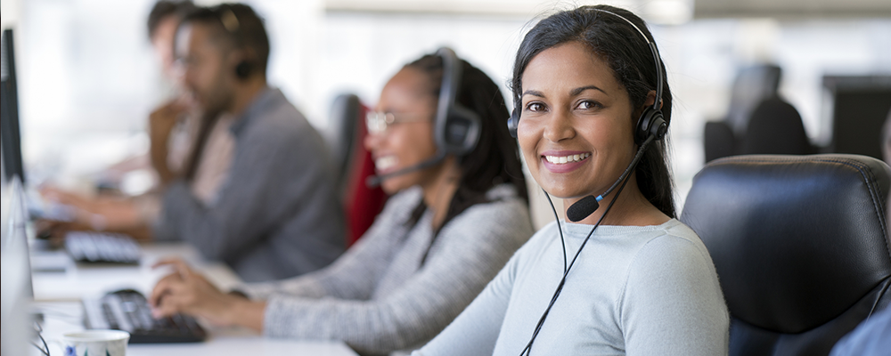 Dominion Diagnostics Client Services team members wearing headsets at their workstations